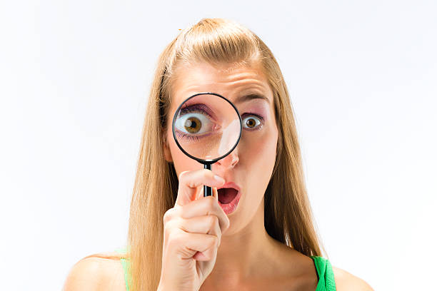 istock Woman looking through magnifying glass or loupe 160503967