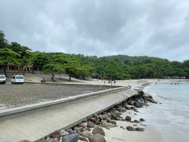 istock Concrete breakwater whose pier rock beds are washed away by sea water waves. 1605059232