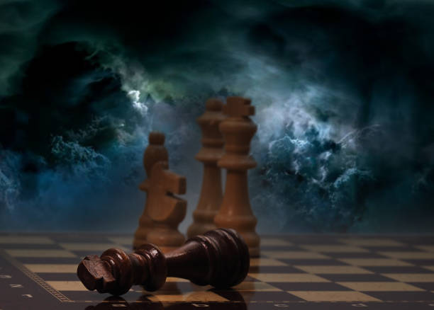 istock Chessboard and pieces in front of cloudy background 1605059465