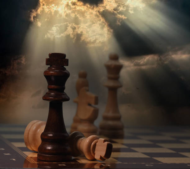 istock Chessboard and pieces in front of cloudy background 1605059731