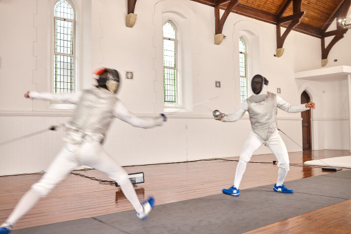 Fencing, sport and men with sword to fight in training, exercise or workout in a hall. Martial arts, match and fencers or people with mask and costume for fitness, competition or target in swordplay