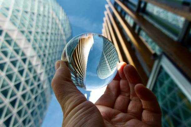 istock Crystal ball against modern buildings 1605060334