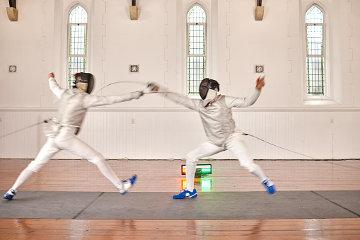 Fight, fencing sword and people in sports training, exercise or workout in a hall. Martial arts, match and fencers or men with mask and costume for fitness, competition or stab target in swordplay