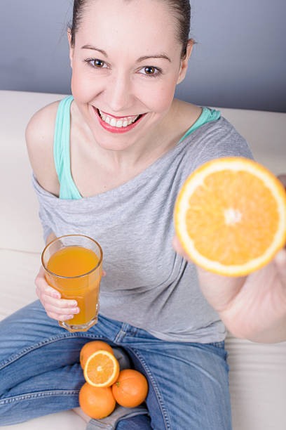 istock Woman drinking orange juice 160507052