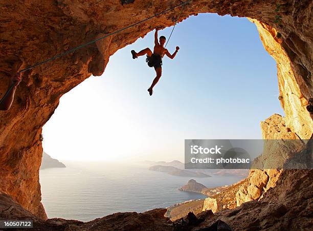 Rock Climber At Sunset Stock Photo - Download Image Now - Hanging, Extreme Sports, Cliff