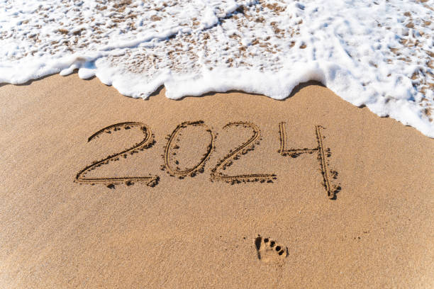 istock 2024 hand written in sand on a beautiful beach 1605078828