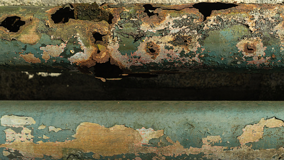 Old metal tubes background. Grunge greeen texture template for overlay artwork.