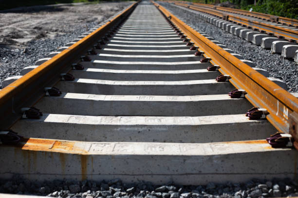 istock Rusty rails and concrete sleepers go into the distance 1605085566