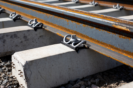 Reinforced concrete rail fastening rails to the sleeper. Spring-loaded metal fastening of the railway track