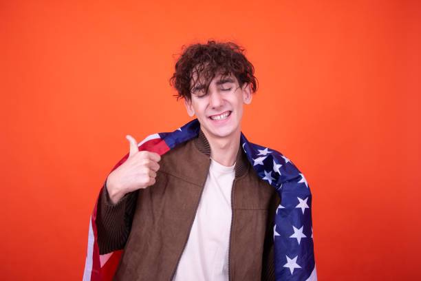 istock Work in advertising. Funny guy posing on an orange background. 1605086109
