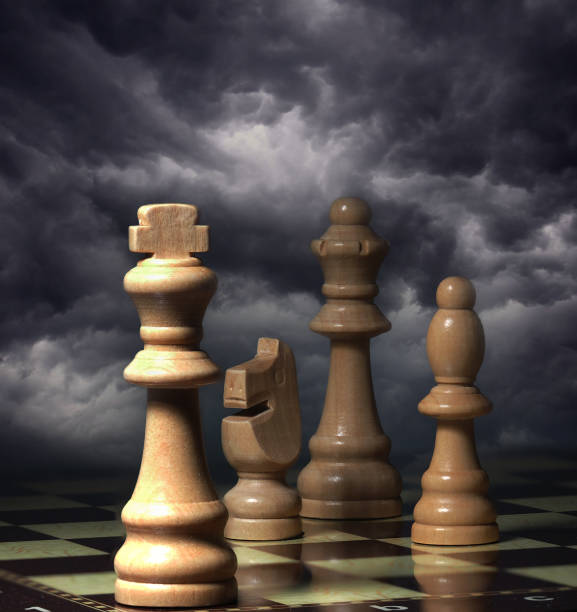 istock Chessboard and pieces in front of cloudy background 1605089407