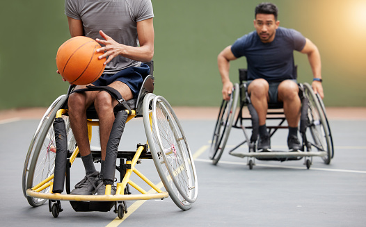 Fitness, basketball and men in wheelchair on court for training, exercise and workout on outdoor park. Sports, team and male people with disability tackle for ball for competition, practice and games