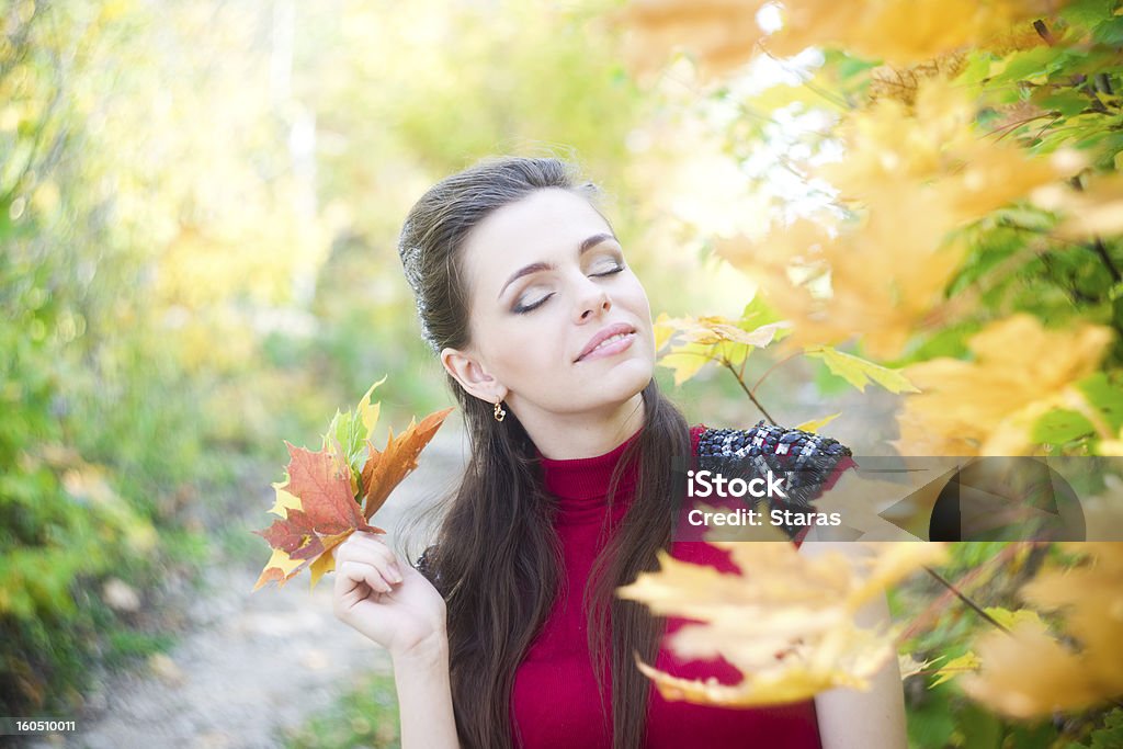 Woman in autumnal park Woman portrait in autumnal park. 20-24 Years Stock Photo