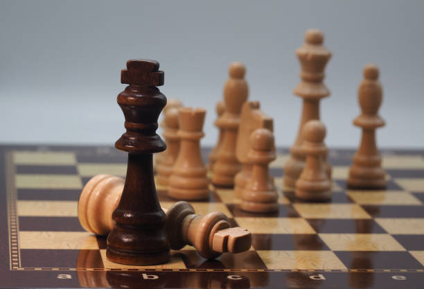 istock Chessboard and pieces in front of grey background 1605102065