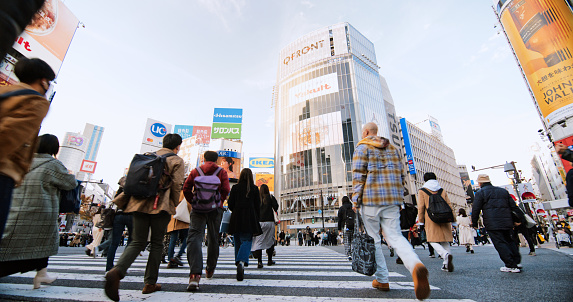 Crowd of Japanese people, commuter, traveler walk cross road at Shibuya scramble crossing. Tokyo tourist attraction landmark, traffic transportation, Japan tourism, Asia transport, Asian city life