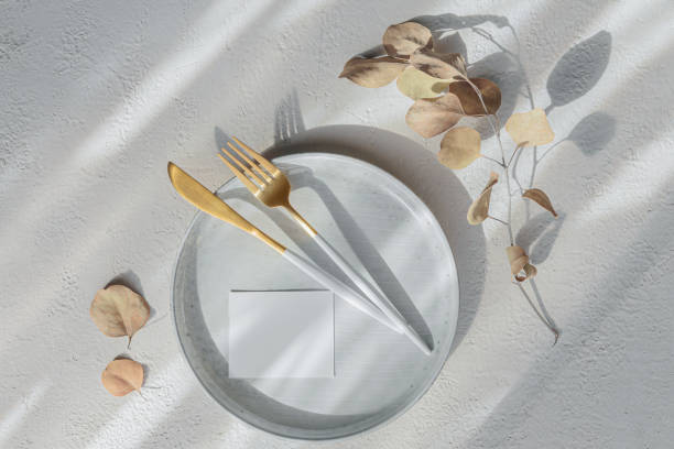 istock Golden modern cutlery, dried eucalyptus branch, ceramic plate 1605110766