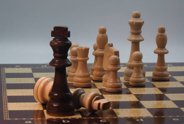 istock Chessboard and pieces in front of grey background 1605111287