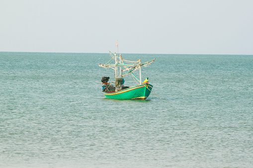 small fishing boat that catches fish and squid along the coast in a traditional way and maintains an ecosystem of fish and marine life for a long time on strong and windy days.