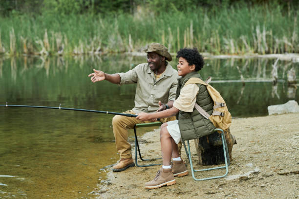 istock Son fishing together with his dad 1605122154