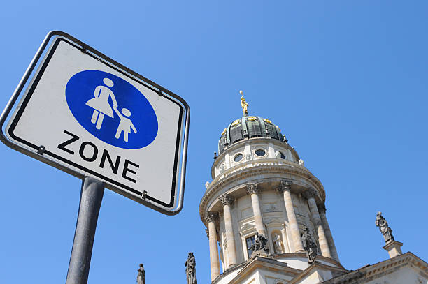 French Cathedral at Gendarmenmarkt (Berlin Germany) is located next to German cathedral. in front road sign of pedestrian zone.