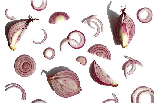 Abstract background of cut different slices of purple onion.