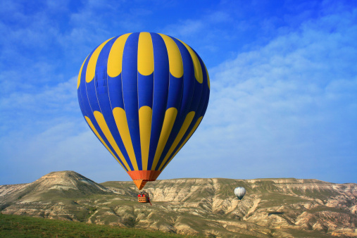 Hot Air Ballons flying on the sky of ancient rocky Cappadocia