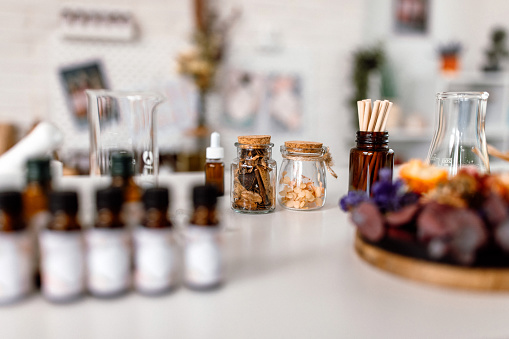 Different ingredients and tools on desk in home cosmetics workshop