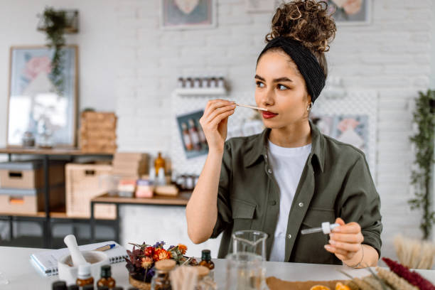 istock Woman testing new perfume note in her cosmetics workshop store 1605145289