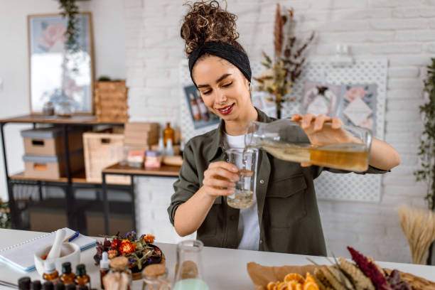 istock Woman testing new perfume note in her cosmetics workshop store 1605145291