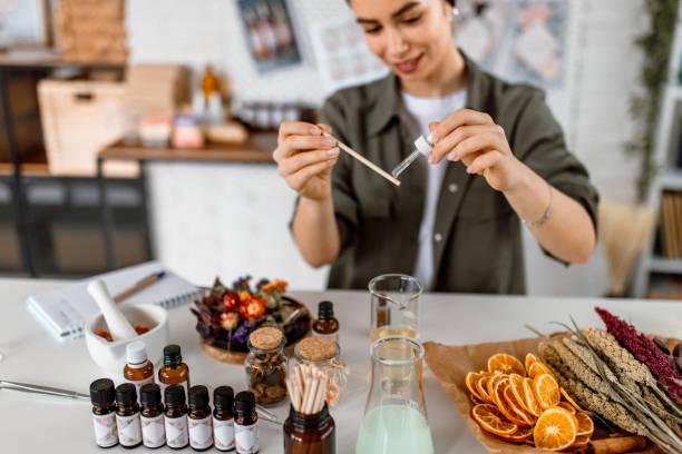 istock Woman testing new perfume note in her cosmetics workshop store 1605146893