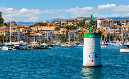 Cannes, France - July 31, 2022: Cannes seafront panorama with castle hill over historic old town Centre Ville quarter and yacht port at French Riviera of Mediterranean Sea