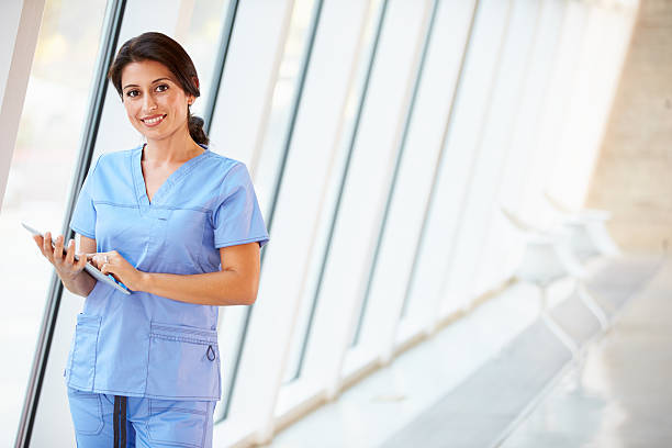 istock Nurse Using Digital Tablet In Corridor Of Modern Hospital 160515467