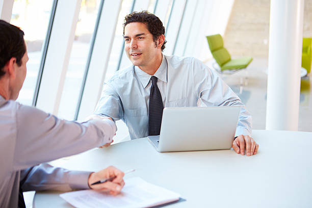 istock Two Businessmen Having Meeting Around Table 160515625