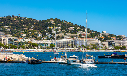 Cannes, France - July 31, 2022: Cannes city center seafront panorama with historic old town Centre Ville quarter and yacht port onshore Mediterranean Sea of French Riviera