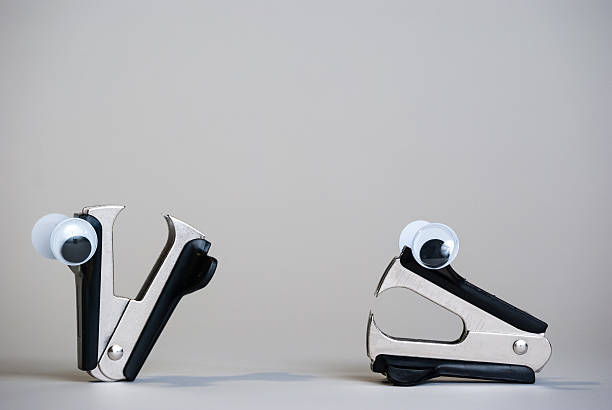 Personified Staple Removers with Oogly Eyes stock photo