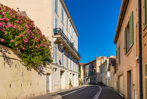 Cannes, France - July 31, 2022: Historic tenement houses at Rue Louis Perrissol street in Castle Hill old town quarter of Cannes at French Riviera of Mediterranean Sea