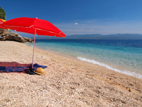 Parasol on paradise Adriatic beach, Dalmatia, Croatia.
