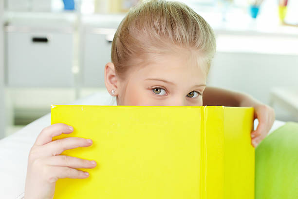 istock Peeking out of book 160519224