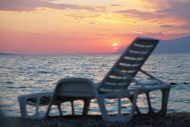 istock white plastic sunbed against mediterranean ocean sunset 160519839