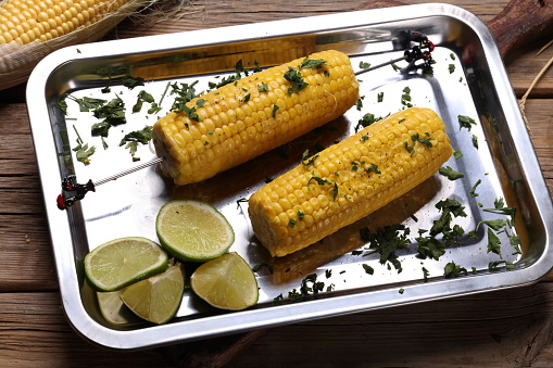 grilled corn on black plate, top view