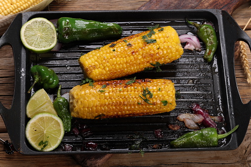Corn on the Cob fried in butter with Padron Peppers