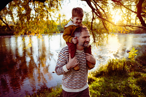 Father and son enjoying a carefree autumn day in nature.