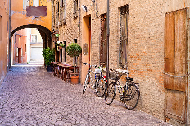 Milan, Italy - December 30,2011: Old restaurant in Milan. A man crosses the road with bike