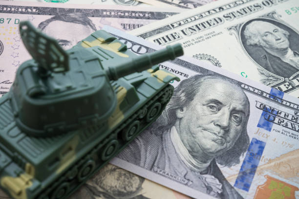 istock The main battle tank on US dollar banknotes background. 1605238349