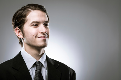 Portrait of young adult male professional wearing business suit. He is looking away from camera in modern studio shot.Portrait of young adult male professional wearing business suit. He is looking away from camera in modern studio shot.Portrait of young adult male professional wearing business suit. He is looking away from camera in modern studio shot.