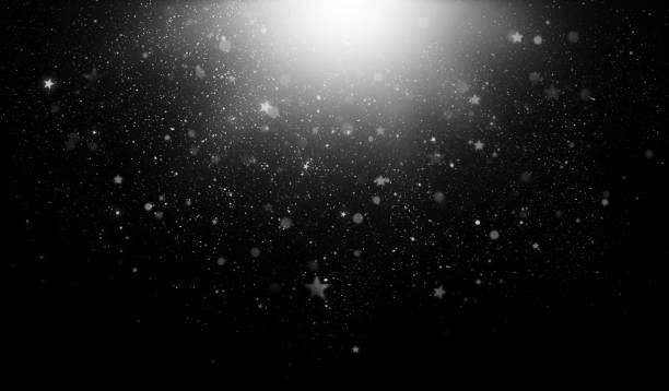 istock abstract black background with white specks, stars and a flash of light 1605250260