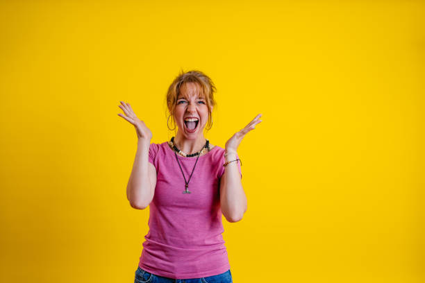 istock Surprised Young Woman Standing Against A Yellow Background 1605250768