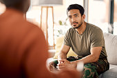 Listen, therapy and a military man with a psychologist for counselling, support and psychology. Young army, veteran or soldier person on therapist couch for mental health, consultation or help