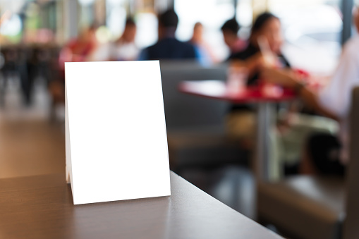 MenuÂ mock up blank for text marketing promotion. Mock up Menu frame standing on wood table in restaurant space for text