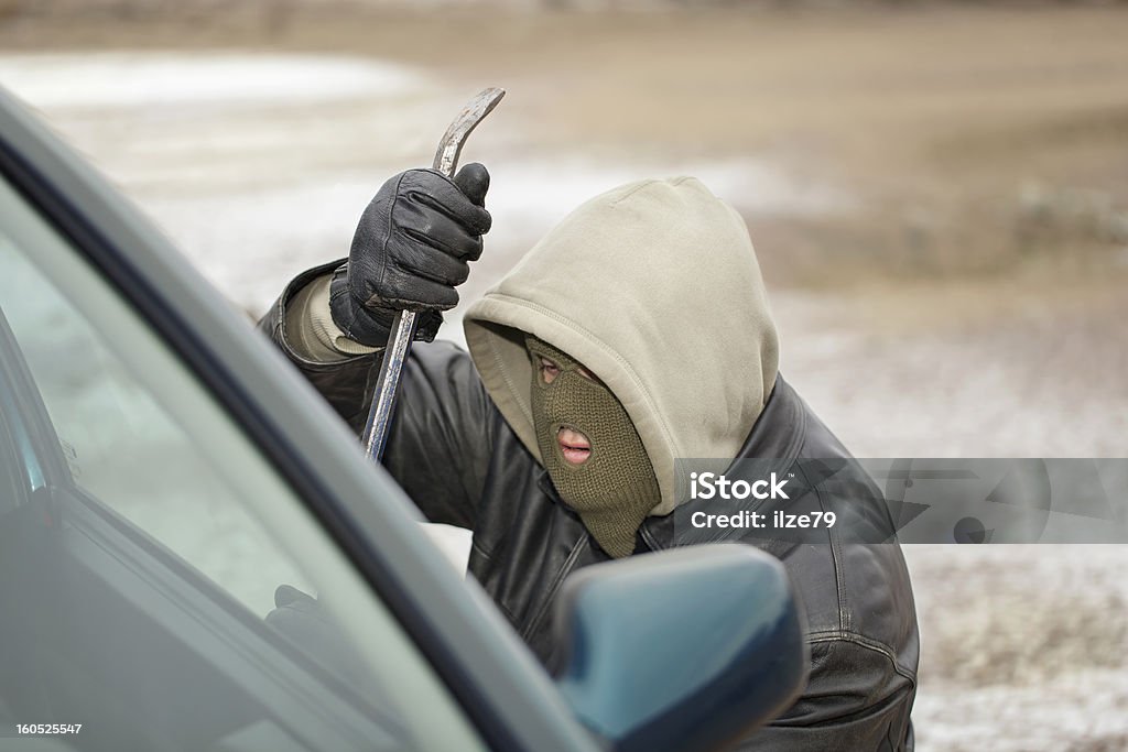 Robber Robber trying to break open the car door Adult Stock Photo